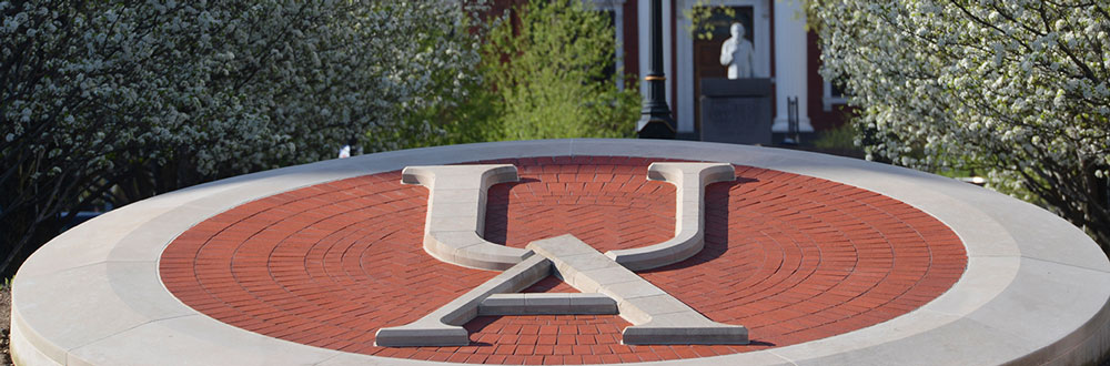 A decorative ϲ in stone is located in the center of campus.